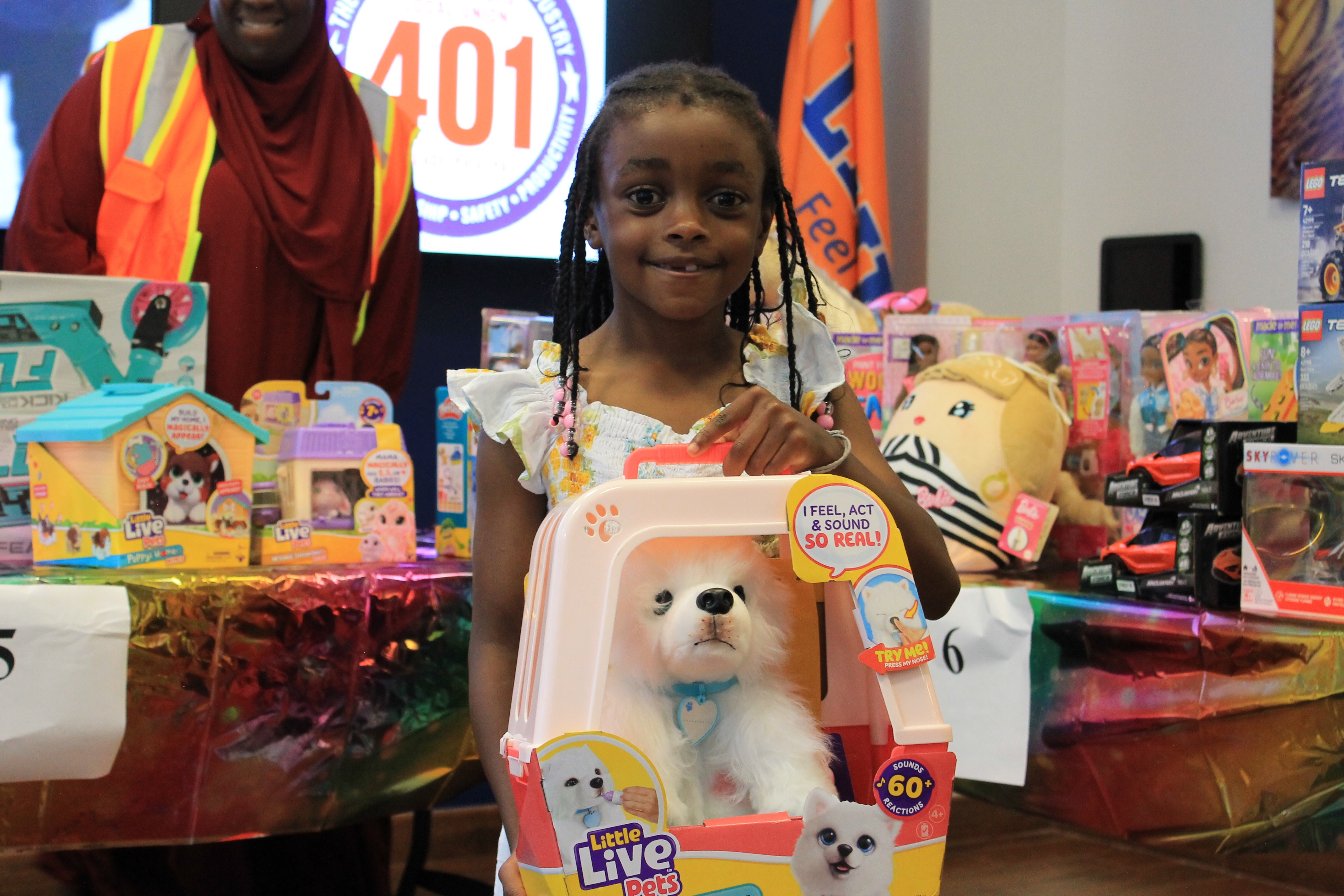 Child receiving toys at M4H event