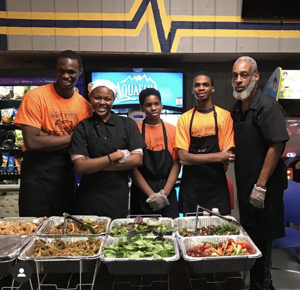 West Philly youth serving healthy food with mentor